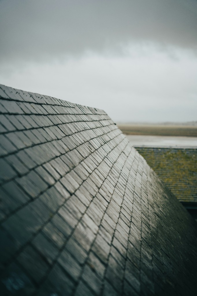 Dark slate roof under an overcast sky